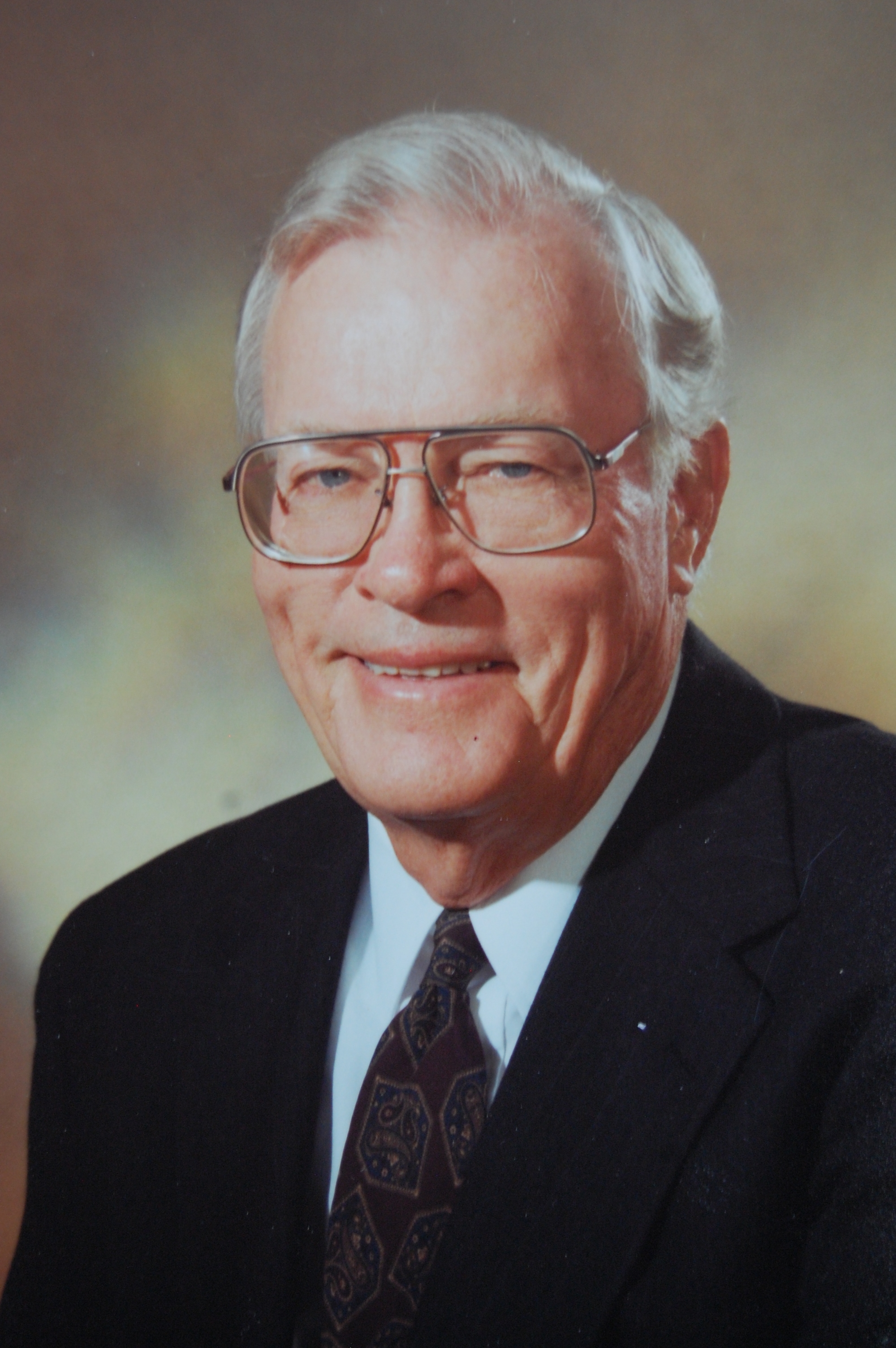 Bob Bingham, the firm's founder, in a dark suit and patterned tie