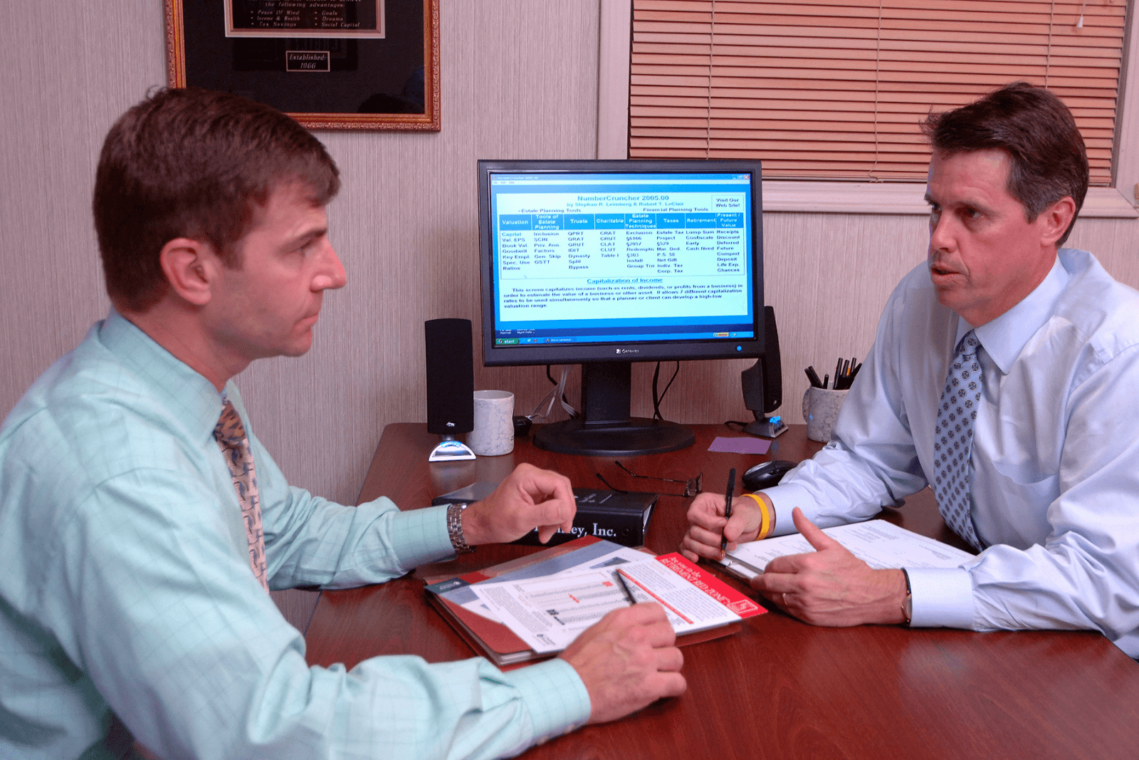 Jeff Bingham in conversation with a client across the conference table in the Kingsport office.